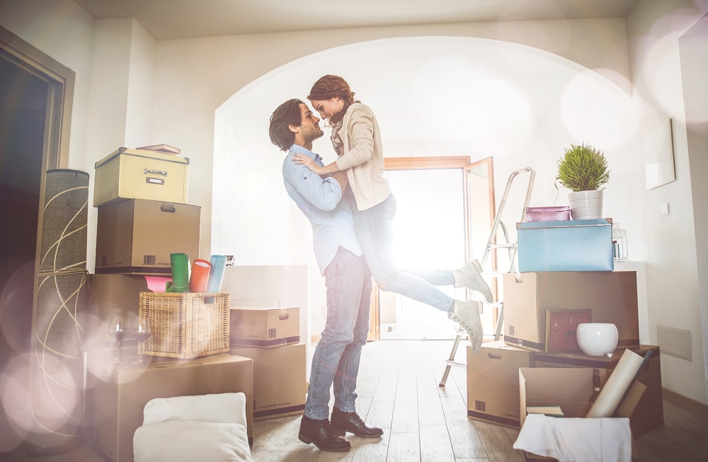 Young couple moving in into new apartment